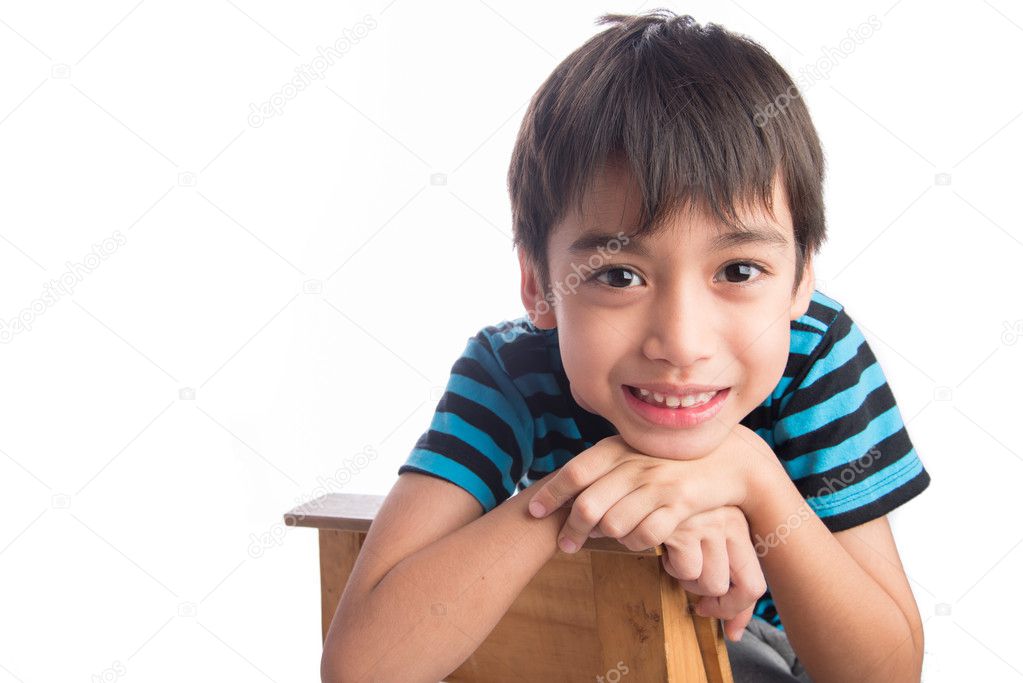 Little boy sitting on the wood chair on white background