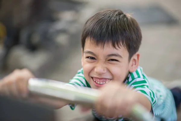 Primer plano de Little cute boy jugando slider en el patio de recreo —  Fotos de Stock