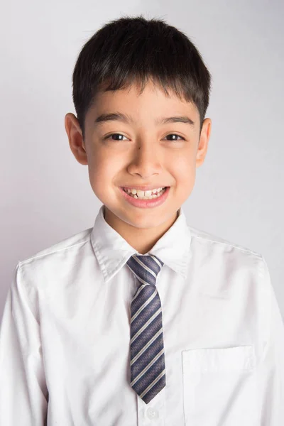 Портрет маленького хлопчика в шкільній формі білої сорочки — стокове фото