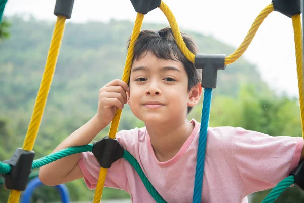 Liten pojke klättring rep på lekplats — Stockfoto