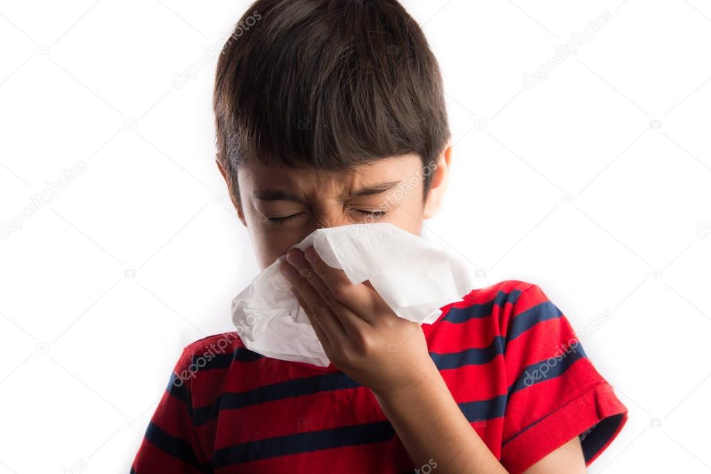 Little boy using tissue  cleaning nose 
