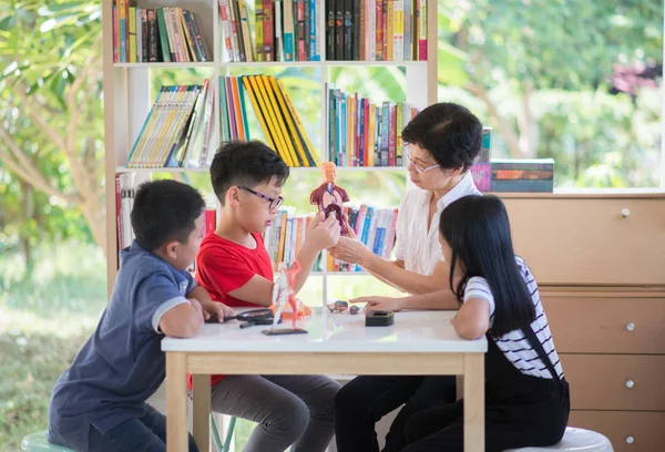 Asian Students and teach study biology scicence in the outdoor classroom