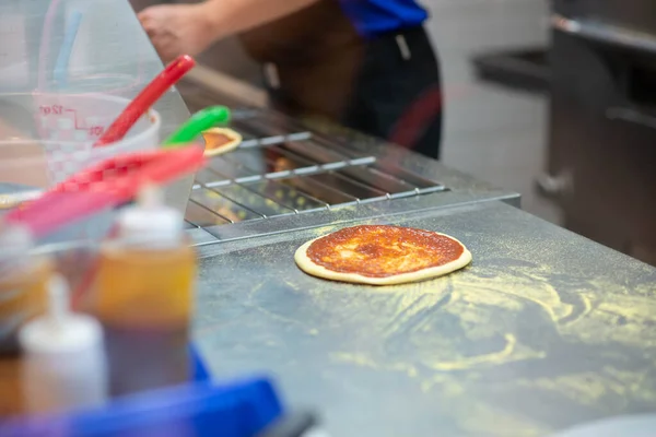 Worker making pizza in the restuarant