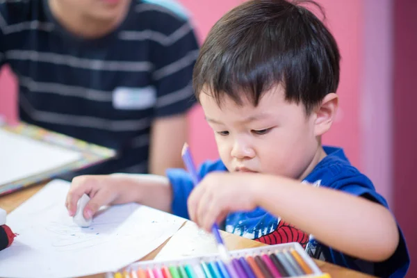 Kid learning art painting and crafting in the art classroom