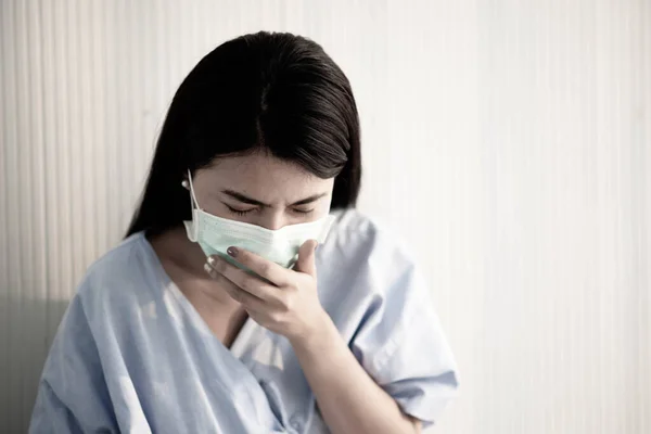 Asian patient woman wearing mask protect virus from sickness in hospital