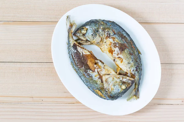 Fried two short mackerel fishes on wooden floor — Stock Photo, Image