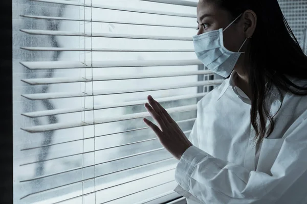 Black long hair woman get flu, she wear the hygienic mask even in the hospital, she wanna get out of the hospital.