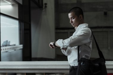 Taylandlı saati kontrol etmek için saatine bakıyor..