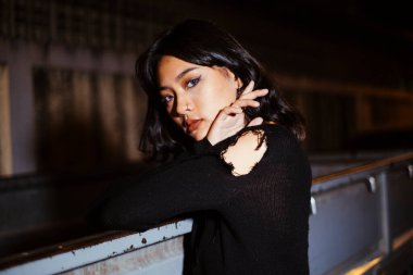 Karanlıkta parlayan genç Taylandlı kızın portresi.