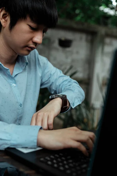 Freelance man looking at his watch 'cause his working time is running out, ha must work againt time.