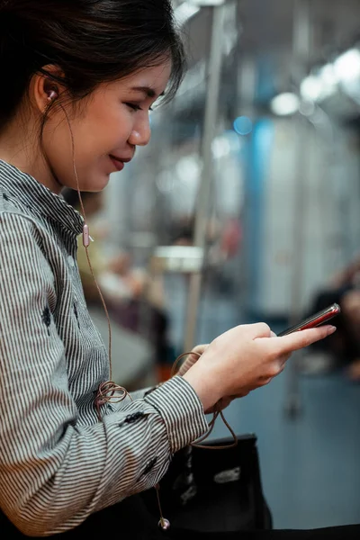 Seorang Wanita Dengan Pakaian Formal Tersenyum Sambil Menggunakan Smartphone Nya — Stok Foto