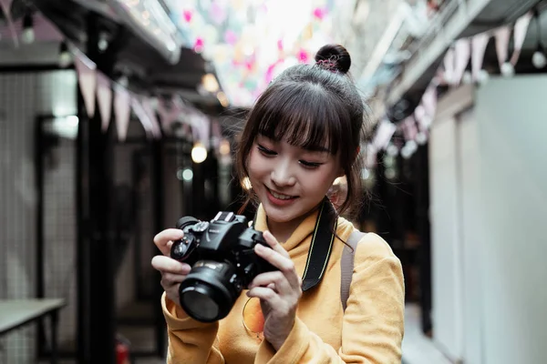 可愛いです女の子身に着けている黄色セーター見ますカメラ — ストック写真