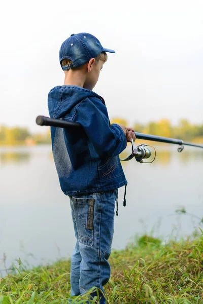 河岸边的渔夫男孩手里拿着钓竿 — 图库照片