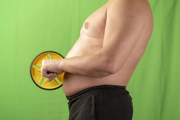 Der Mann mit dem Bauch hält den Apparat in der Hand. Übergewicht. — Stockfoto