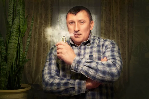 A férfi egy elektromos cigarettával. Gőzt áraszt a gőz. A szokásos cigaretták cseréje. — Stock Fotó