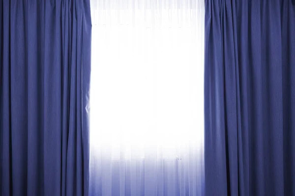 Classic blue color curtains with a copy space in the middle