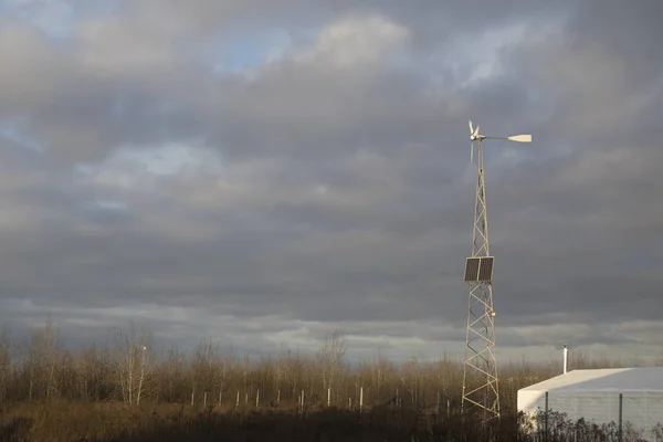 Wind turbines and solar panels against cloudy sky. generating alternative electricity. — 스톡 사진