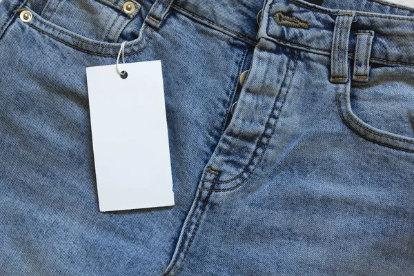 Element of jeans pants with white tag label. — Stock Photo, Image