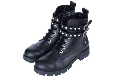 Black leather boots with metal fittings and knobs isolated on white background.