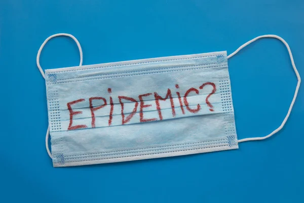 Medicine mask with Epidemic word on blue background