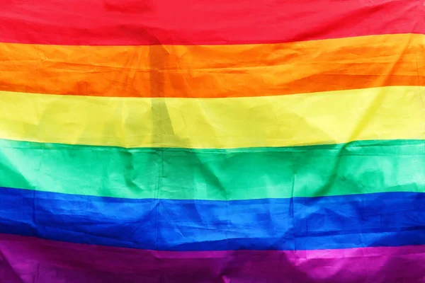 Textura de la tela de la bandera gay LGBTQ arco iris colores fondo — Foto de Stock