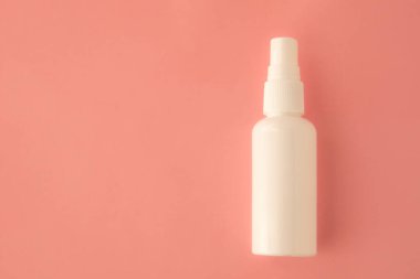 Beyaz şişedeki antibakteriyel spreyi temizliyorum. Coronavirus önleme kavramı.