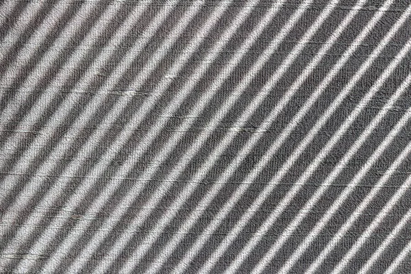 Hard diagonal shadows on grey textured wall from a window roller shutter or blinds. Attractive abstract composition — Stock Photo, Image