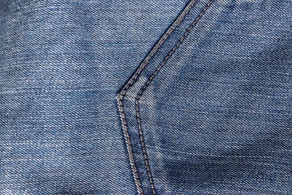 Top kilátás farmer textúra öltéssel. Vászon farmer háttér kék szín részletekkel — Stock Fotó