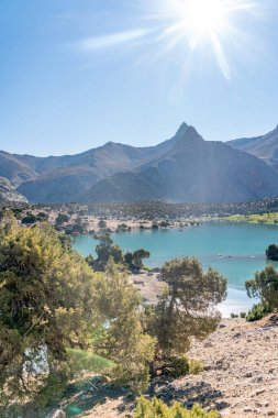 Pamir sıradağları manzarası ve Tacikistan 'daki Fann Dağları' ndaki Kulikalon Gölü 'ndeki huzurlu kamp alanı. Saf buz gölünün rengarenk yansıması.