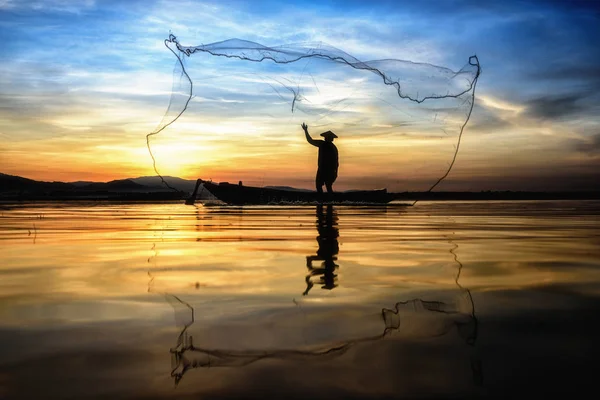 Fisherman in action when fishing in the lake — Stock Photo, Image