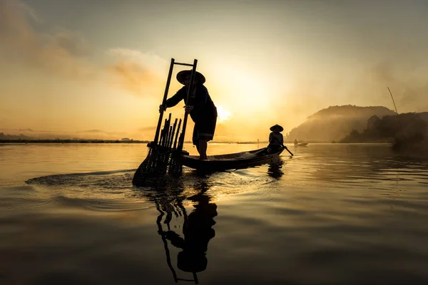 Pescador en acción al pescar en el lago — Foto de Stock