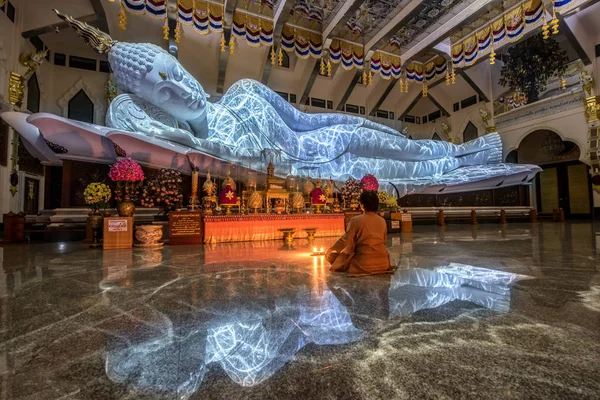 The biggest white marble nirvana buddha with the texture from lighting at Wat Pa Phu Kon, Udon Thani Thailand