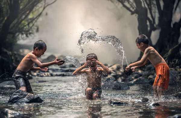 Three boys joyful with splashing — Stock Photo, Image