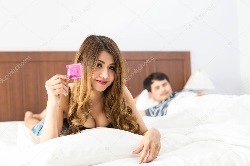 Girl with condom before sex with her partner