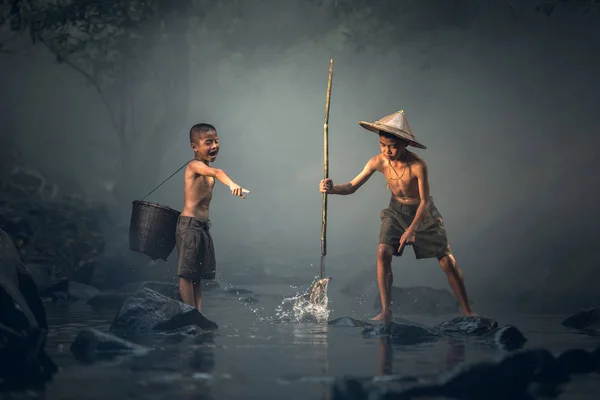 Asian boy fishing in a river — Stock Photo, Image