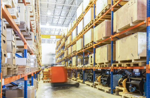 Large modern warehouse with moving forklifts — Stock Photo, Image