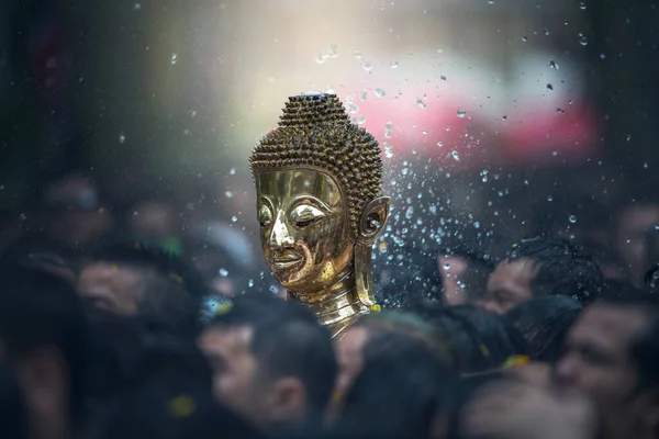 Buddha statues , Face of gold buddha, Songkran Festival, People come to bathing the statue of Luang Pho Phra Sai With respect to faith at Wat Pochai Temple, Nong Khai, Thailand