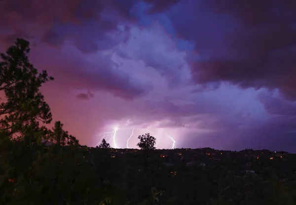 A monsoon lightning storm hits Arizona right after sunset, and accents the dramatic sky\'s colors.
