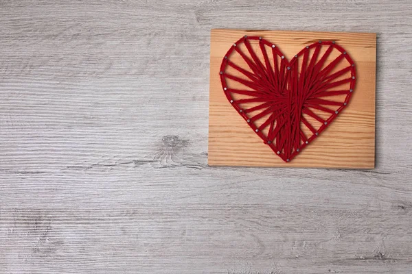 Valentine\'s day string art red heart with space for greetings.