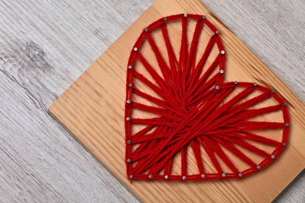 Valentine\'s day string art red heart framed photo close-up