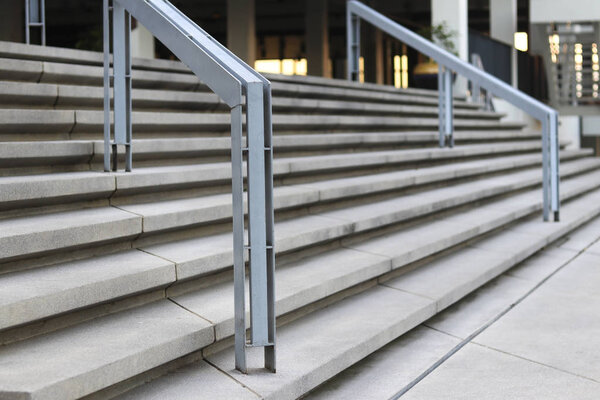Stairs and handrails to the front of the building. Stairs and handrails made of steel.