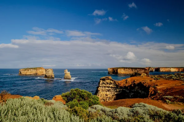 Bay of Martyrs. Tourist attraction on the Great Ocean Road. Rock formation in the ocean. Foreground with bushes. Australia landscape. Victoria, Australia