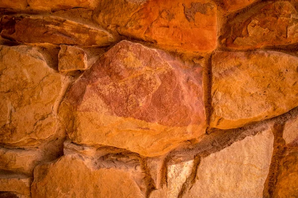 Stone texture. Brown and terracotta rock background. Surface of the rock. Close up of rock texture. Background for design. Copy space.