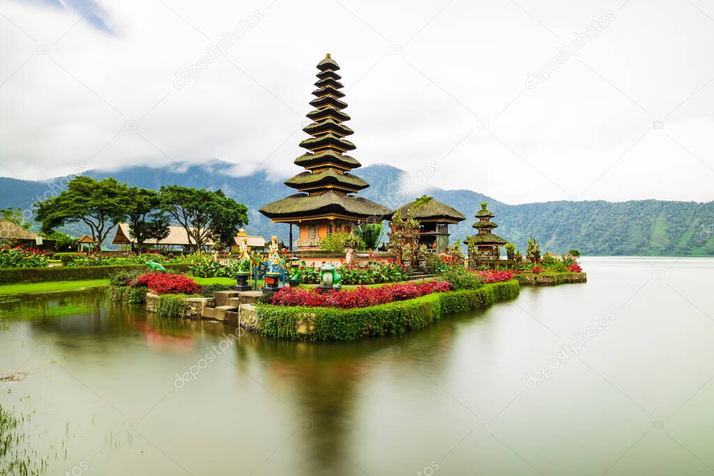 Pura Ulun Danu Bratan temple in Bali island. Beautiful balinese temple. Balinese landmark. Rainy, cloudy and foggy weather. Water reflection. Slow shutter speed. Bratan lake, Bali, Indonesia