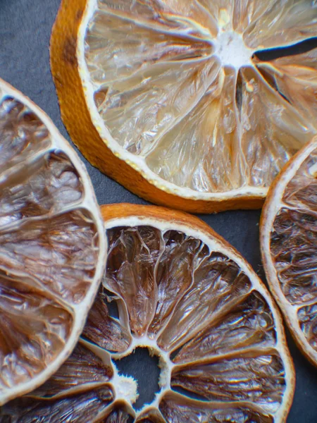 slices of dried citrus fruits. Grapefruit, lime, orange, lemon. Dehydrated fruits for decorating dishes for drinks, desserts and cocktails. Top view macro photo
