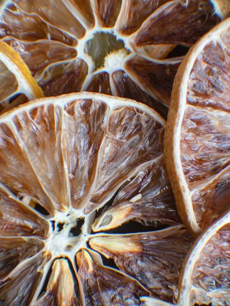slices of dried citrus fruits. Grapefruit, lime, orange, lemon. Dehydrated fruits for decorating dishes for drinks, desserts and cocktails. Top view macro photo