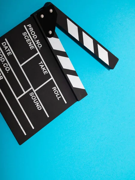 Movie production clapper board isolated on blue background. movie clapper isolated on blue. film making production. empty space for text