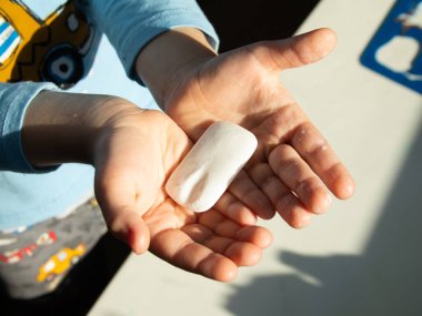 Küçük bir çocuk banyoda yemek yemeden önce ellerini yıkar. Temizlik ve hijyen kavramı. El hijyeni koronovirüste.