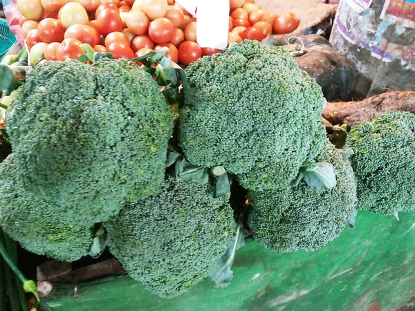 Fresh Green Cauliflower. Group of cauliflowers with green leaves.Broccoli, cauliflower and roman cauliflower in wooden bowl isolated on shop in Bangladesh. Vegetables with copy space for text.