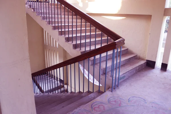 Rangpur,Bangladesh. February 18, 2020. Staircase with wood railing.Stairs in a modern College University building.Luxury custom built home interior. white walls and a staircase.Spiral staircase